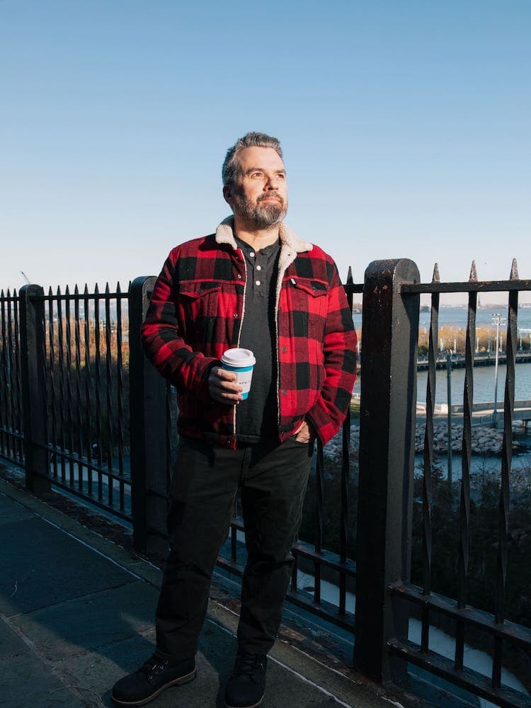 portrait of chris dooley outside with coffee