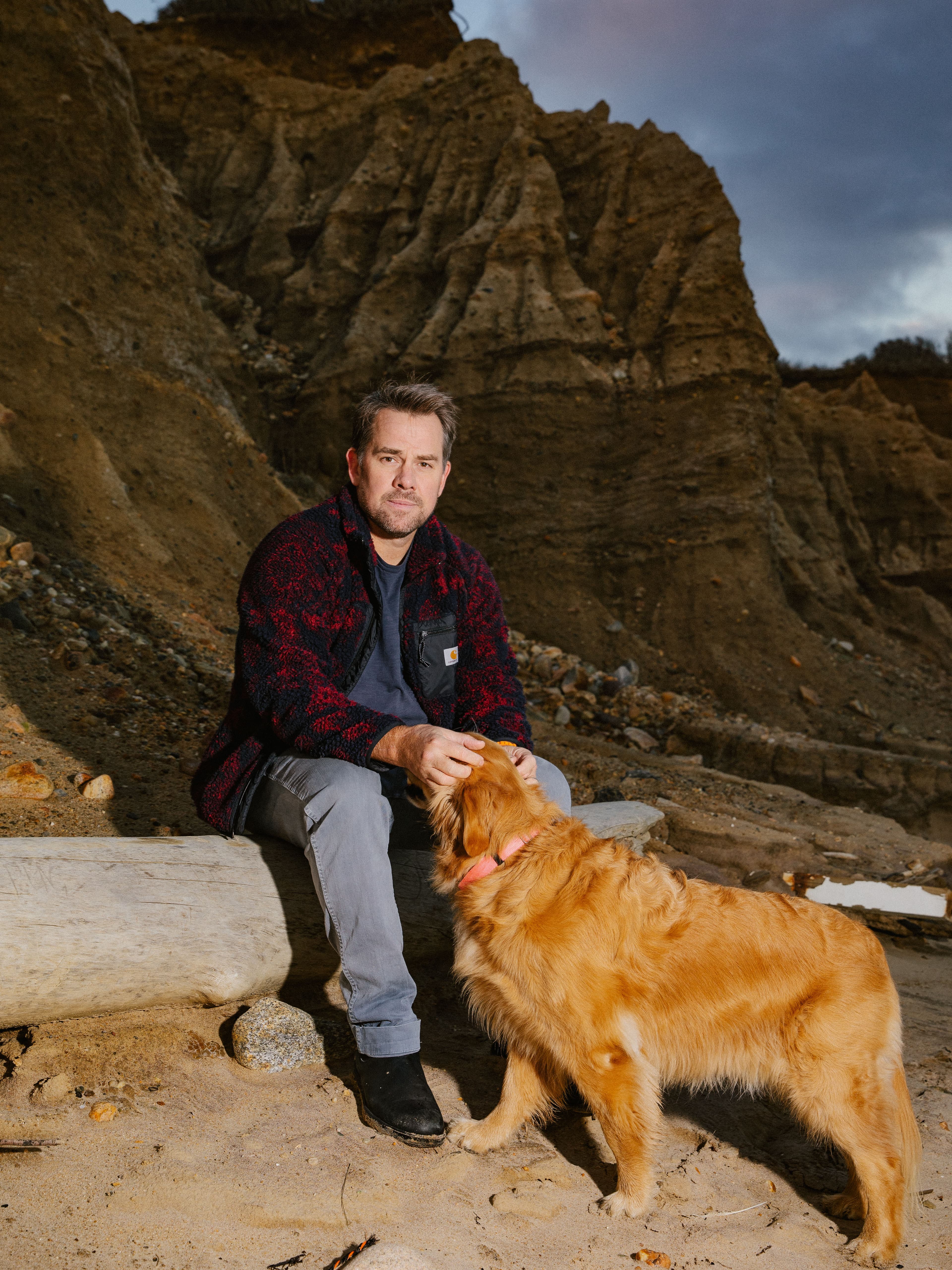 portrait of jonathan notaro and his golden retriever dog